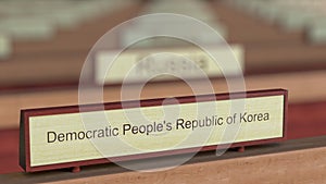 Democratic People`s Republic of Korea DPRK name sign among different countries plaques at international organization. 3D