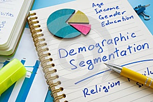 Demographic segmentation list on the page and papers. photo