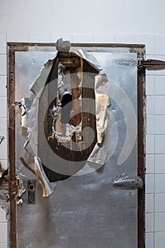 a demolished metal door, like from a zombie apocalypse