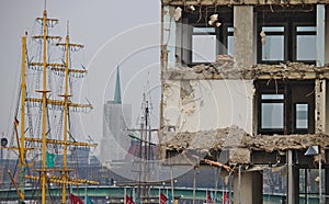 Demolished office building with sailship in the background