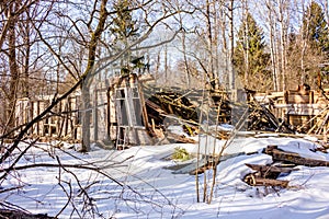 Demolished wooden structure in a forest area in winter