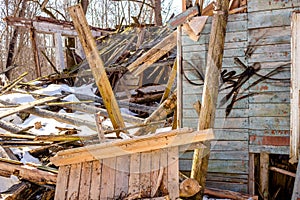 Demolished wooden structure in a forest area in winter