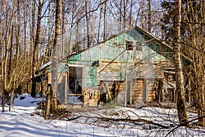 Demolished wooden structure in a forest area in winter