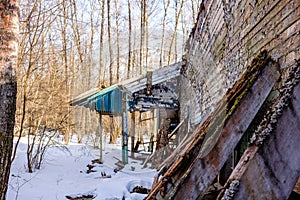 Demolished wooden structure in a forest area in winter