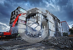Demolishing building with crane