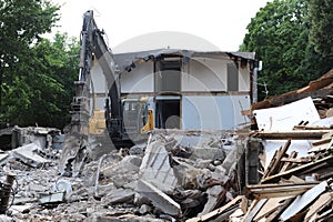 Demolition of a building in deconstruction site with debris, remains and ruined walls