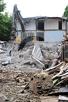 Demolition of a building in deconstruction site with debris, remains and ruined walls