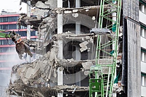 Demolition of a building with an excavator