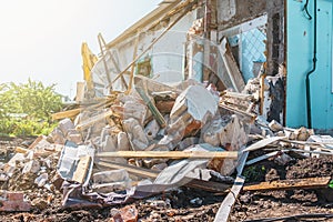 Demolition of building. Ruins of demolished house with broken wall, debris of bricks