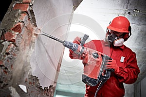 Demolition and construction destroying. worker with hammer breaking interior wall plastering