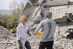 Demolition control supervisor and foreman discussing on demolish building