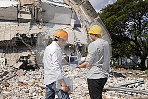 Demolition control supervisor and foreman discussing on demolish building