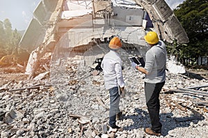 Demolition control supervisor and foreman discussing on demolish building photo