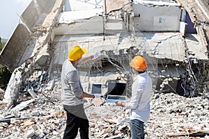Demolition control supervisor and foreman discussing on demolish building