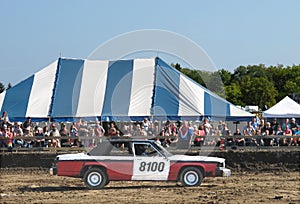 Demolition derby car and crowd