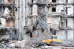 Demolition and destruction of a building using excavator. Destroyers equipment