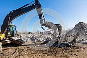Demolition Excavator Pulverizer with Hydraulic Crusher Shearing Equipment Working at Construction Site