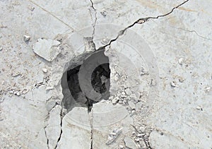 Demolition hole in a large concrete white plate