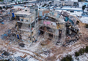 Demolition of the mall. Renovation in Russia. Drone view. Destruction of building structures. Pile of rubble from a