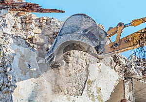 Demolition of an old house with excavator