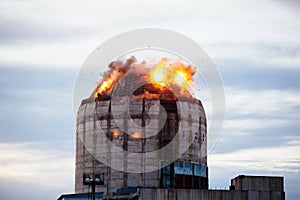 Demolition of old industrial building by exploding dynamite