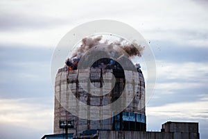 Demolition of old industrial building by exploding dynamite