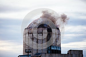 Demolition of old industrial building by exploding dynamite