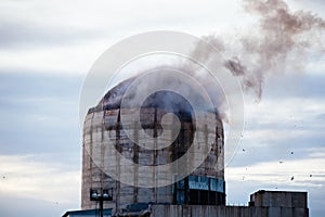 Demolition of old industrial building by exploding dynamite