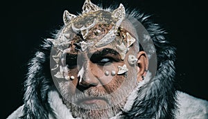 Demon head with thorns on face isolated on black background. Creepy winter spirit, Jack Frost. Closeup portrait of man