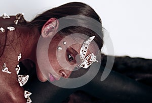 Demon with red skin over black and white background. Creature from hell. Portrait of girl with creative diabolic make-up