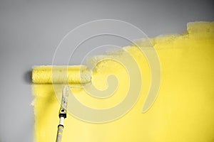 Demonstrating trendy Color of the Year 2021. Illuminating Yellow and Ultimate Gray. Brush and open paint can with on