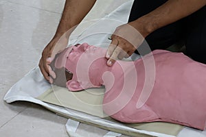 Demonstration of artificial respiration using a dummy, medical concept, emergency rescue training.