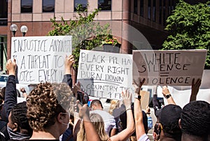 Demonstrators Hold Up Signs at a Protest of the Murder of George Floyd