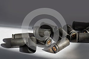 Demounted bullet shells on gray background light reflection