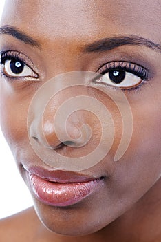 Demure Beauty. Closeup studio shot of a young beautiful african american model isolated on white.