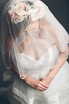 Demure bride with her veil over her face