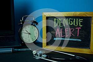 Dengue Alert Planning on Background of Working Table with Office Supplies.
