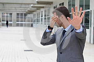 Denial concept with businessman covering his eyes