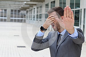 Denial concept with businessman covering his eyes photo