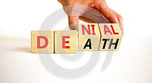 Denial death symbol. Concept words Denial Death on wooden block. Beautiful white table white background. Businessman hand.