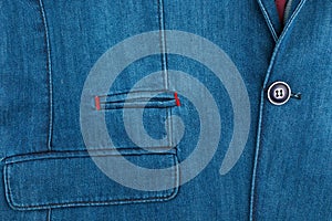 Denim blue formal suit with a pocket fragment for background. Elegant denim suit. Male jacket with pocket and buttons