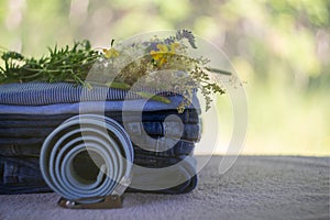 Denim blue jeans stack on a blurred natural background. Accessory belt denim.