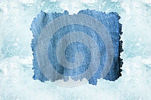 A denim cloth against a light blue water backgroun