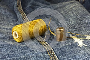 Denim fabric with needle, thread and thimble