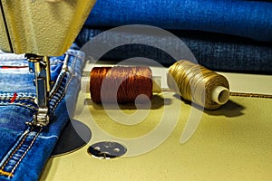 Denim fabric on the sewing machine. Close-up of the sewing process.