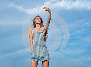 Denim girl. Woman in jeans dress. Beauty and fashion. Sexy girl woman in sunglasses with long hair.