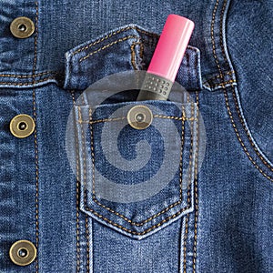 Denim jacket pocket with stitches. Casual wear. Jean jacket. A pink marker sticks out of a pocket.