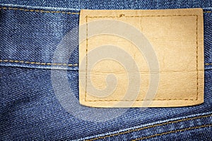Denim jeans fabric texture or denim jeans background with blank leather label.