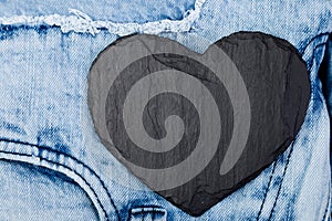 Denim. Jeans texture background. Valentine Day. Black Stone Slate heart. Copy space.