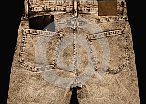 Denim jeans with a wallet in back pocket, in dark